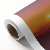 Rolled canvas showcasing a vibrant desert landscape artwork with warm hues of orange and yellow, elegantly packaged in a durable cardboard tube for safe shipping.