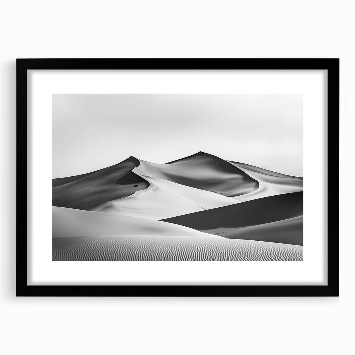 Framed landscape art print depicting serene sand dunes in a minimalist black frame, accented with a white mat, perfect for modern home decor.