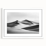 Framed landscape artwork showcasing serene sand dunes in soft beige and golden tones, set in a sleek white mat and frame, ideal for modern home decor.