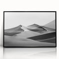Framed acrylic artwork showcasing a serene desert landscape with golden sand dunes, featuring a sleek black frame, ideal for modern home decor.