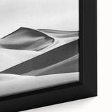 Close-up of a framed canvas artwork depicting serene desert dunes at sunset, showcasing warm golden and orange hues with intricate texture details, perfect for home decor.