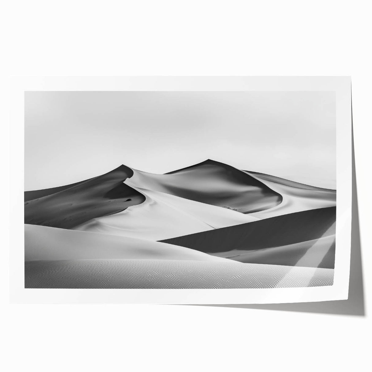 Stunning rolled print showcasing a serene desert landscape with golden dunes under a vibrant blue sky, elegantly packaged in a protective cardboard tube for art lovers.