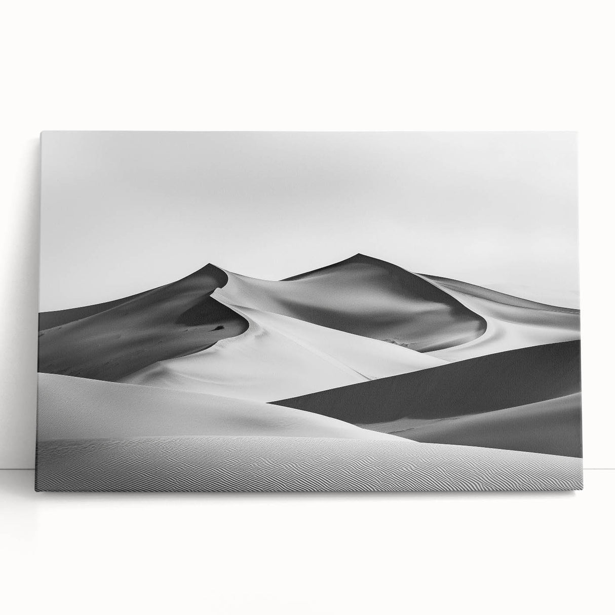Stretched canvas artwork depicting serene sand dunes at sunset, showcasing warm hues of orange and gold, perfect for enhancing modern home decor or office spaces.