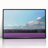 Framed acrylic artwork showcasing a serene landscape with vibrant green fields and a clear blue sky, elegantly presented in a sleek black frame, ideal for home decor.