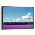 Framed canvas artwork depicting a serene landscape of rolling fields under a vibrant blue sky, showcasing a sleek black frame that enhances the natural colors and textures. Ideal for home decor, this piece adds a touch of tranquility to any space.