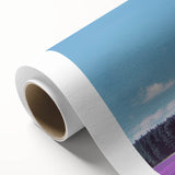Rolled canvas artwork showcasing a vibrant landscape with fields under a clear blue sky, elegantly packaged in a protective cardboard tube for easy transport.