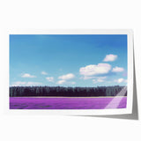 Rolled landscape canvas print showcasing vibrant green fields under a bright blue sky, designed for interior decor, packaged securely in a protective tube.