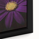 Close-up of a black framed canvas featuring a textured floral design in vibrant colors, suitable for living room decor.