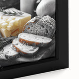 Close-up of a black wall art on framed canvas featuring colorful, textured depictions of various food dishes.