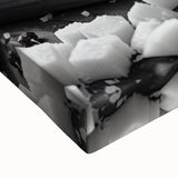 Large art of a black and white landscape painting on stretched canvas, depicting various food dishes.