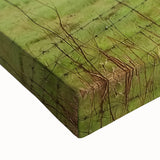 Close-up of a stretched canvas print depicting a vibrant landscape scene with a rustic barn, showcasing rich colors and intricate details, perfect for home decor.