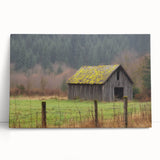 Stretched canvas art depicting a serene landscape featuring a rustic barn surrounded by lush greenery and a vibrant blue sky, perfect for home decor.