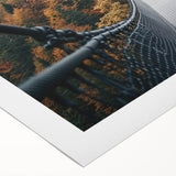 Rolled canvas showcasing a vibrant landscape bridge design, featuring rich colors and intricate details, elegantly packaged in a protective cardboard tube for safe delivery.