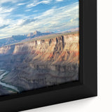 Close-up of a framed canvas print showcasing a stunning landscape of vibrant canyons, featuring rich earthy tones and intricate details that evoke a sense of adventure and natural beauty. Perfect for enhancing home decor with an artistic touch.