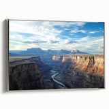 Framed canvas artwork showcasing a stunning landscape of canyons in rich earth tones, elegantly displayed with a silver frame, perfect for enhancing interior decor.