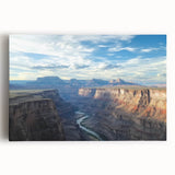 Stretched canvas artwork depicting vibrant landscape canyons in rich earth tones, showcasing dramatic rock formations and a serene sky, perfect for home decor.