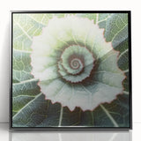 Large abstract wall art featuring close-up leaves in green and yellow, framed in black acrylic.