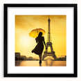 Colorful abstract art print of Paris scenery in vibrant hues on textured canvas, framed in black.