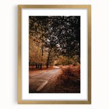 Extra large abstract art print of autumn trees in vibrant orange and red hues, framed in gold, ideal for living room decor.