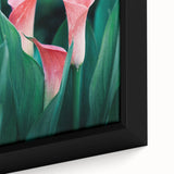 Close-up of a black framed canvas featuring textured, colorful abstract design.