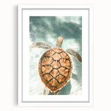 Abstract art print featuring swirls of blue and green on a white framed canvas, ideal for dining room decor.