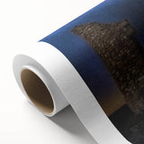 Rolled canvas artwork showcasing a serene landscape featuring a majestic castle surrounded by lush greenery and a vibrant sky, elegantly packaged for display.