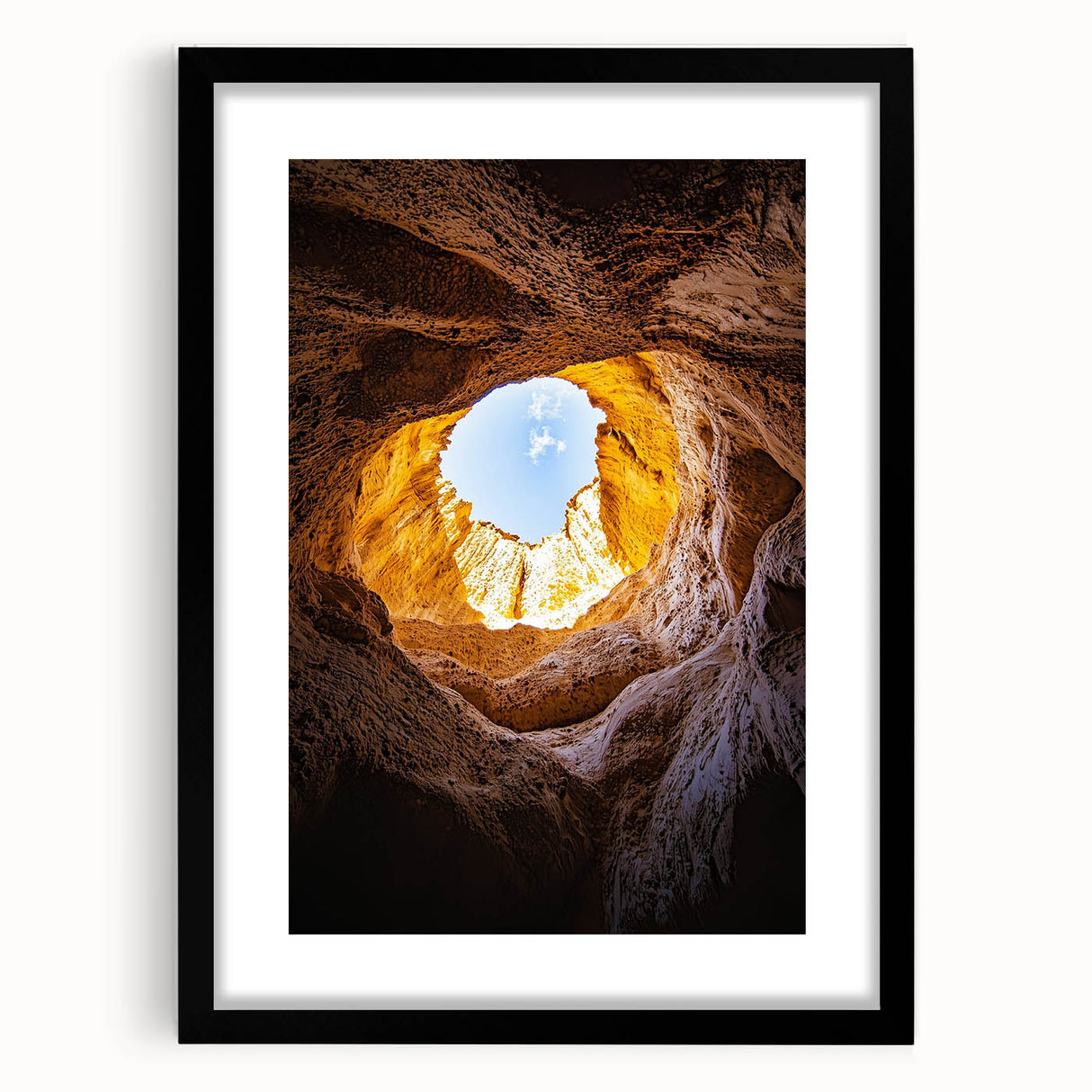 Framed landscape artwork showcasing a stunning cave scene, featuring a black mat and a sleek black frame, ideal for modern home decor. Perfect for nature lovers and art enthusiasts.