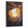 Framed canvas artwork showcasing a stunning cave landscape with rich earthy tones and intricate details, viewed from the side against a neutral backdrop, ideal for home decor.