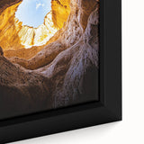Close-up of a framed landscape canvas showcasing intricate cave formations with rich earthy tones, perfect for enhancing home decor and adding a natural element.