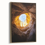 Framed canvas artwork depicting a stunning landscape with caves, featuring rich gold tones and intricate details, ideal for enhancing home decor aesthetics.