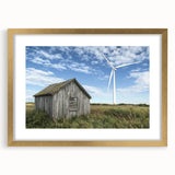 Gold-framed landscape artwork depicting a serene barn scene, with a matting accentuating the rustic charm, ideal for home decor enthusiasts.
