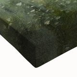 Close-up of a stretched canvas depicting a serene countryside landscape with vibrant green fields, blue sky, and soft clouds, perfect for home decor.