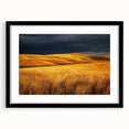 Framed landscape art showcasing a serene countryside scene, featuring lush green fields and a clear blue sky, presented in a sleek black frame with a mat.