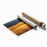 Rolled print showcasing a serene countryside landscape with rolling hills, vibrant green fields, and a clear blue sky, packaged securely for safe delivery.