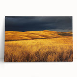 Stretched canvas art depicting a serene countryside landscape with lush green fields and a clear blue sky, leaning against a textured wall, perfect for home decor.