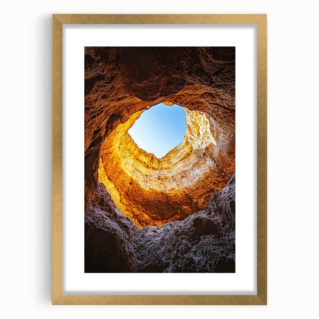 Framed landscape art featuring a serene cave scene, elegantly matted and adorned with a gold frame, perfect for enhancing home decor and adding a touch of sophistication.