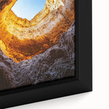 Close-up of a framed canvas depicting a stunning landscape featuring intricate cave designs, showcasing vibrant colors and textures, perfect for home decor.