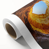 Rolled canvas artwork showcasing a vibrant landscape scene with intricate cave formations, featuring rich colors and textures, ideal for home decor.