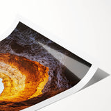 Rolled print showcasing a stunning landscape scene with intricate cave details, featuring vibrant colors and textures, securely packaged in a durable cardboard tube for safe delivery.