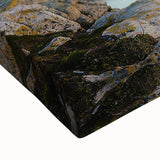Close-up of a stretched canvas art piece depicting dramatic cliffs and landscapes, showcasing rich colors and intricate textures, perfect for home decor.