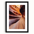 Framed landscape print showcasing vibrant canyons in rich earth tones, set within a sleek black mat, ideal for enhancing modern home décor.