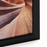 Close-up of a framed landscape canvas depicting vibrant canyons in rich earth tones, showcasing intricate details and textures, perfect for home decor.
