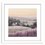 Framed landscape wall art depicting a serene countryside scene with vibrant green fields and a clear blue sky, accented by a white mat for a modern touch.