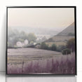 Framed landscape wall art depicting a serene countryside scene with lush greenery and rolling hills, presented in a sleek black frame, perfect for home decor.