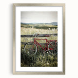 Silver-framed landscape artwork depicting a serene countryside scene, featuring lush greenery and rolling hills, elegantly matted for a polished presentation.