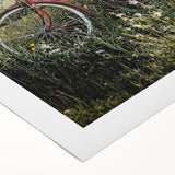 Rolled canvas artwork showcasing a vibrant countryside landscape, featuring lush green fields and a clear blue sky, elegantly packaged in a protective cardboard tube.