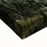 Close-up of a stretched canvas print depicting a serene countryside landscape, showcasing vibrant green fields and a clear blue sky, perfect for home decor.