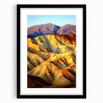 Framed desert landscape print with a black mat, showcasing vibrant hues of orange and yellow against a deep blue sky, perfect for modern home decor.