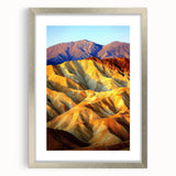 Framed desert landscape artwork in a silver mat, showcasing vibrant hues of orange and brown with intricate details, perfect for home decor.