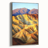 Framed canvas artwork showcasing a desert landscape, featuring warm hues of orange and brown, with a sleek silver frame enhancing its contemporary aesthetic. Perfect for home or office decor, this piece brings a serene desert vibe to any space, making it an ideal choice for nature lovers.